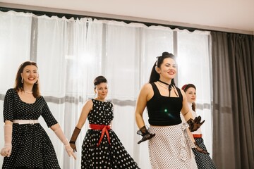 Pinup dancers wearing polka dots performing gracefully in studio