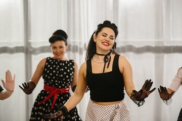 Women wearing polka dots dancing 1950s style pinup
