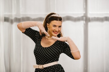 Pinup dancer performing in 1950s style dress and gloves