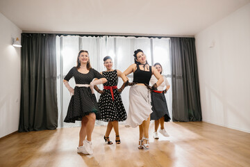 Four pinup dancers showing their choreography in dance studio