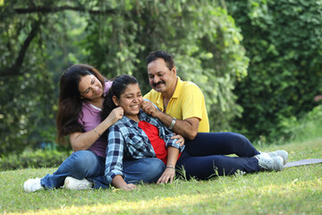 Fototapeta premium Indian happy family fun at park