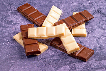 Milk and Dark Chocolate Bars on Marble Background
