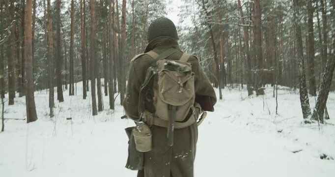 Following For Man Of War. Close-up View On Re-enactor Dressed As American Infantry Soldier Run Through Forest Road Winter Day. Usa Soldier Fast Run By Country Road. Usa Army Soldiers Of World War Ii