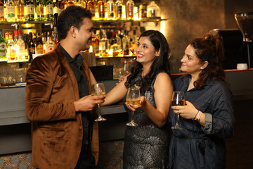 Indian group of friends enjoying evening drinks In bar