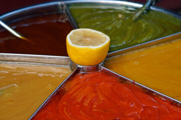 Colorful Turkish macun swirled in container