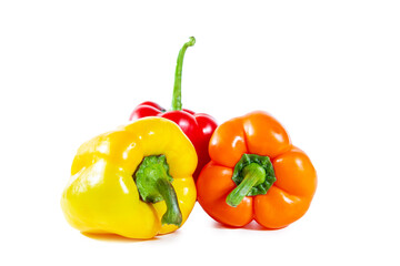 Fresh juicy shiny red, yellow and orange bell peppers. Isolated on white.