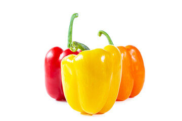 Fresh juicy shiny red, yellow and orange bell peppers. Isolated on white.