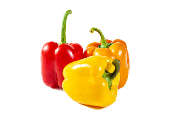 Fresh juicy shiny red, yellow and orange bell peppers. Isolated on white.