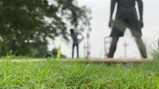 Playing cricket in indian village with blur background.