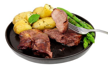 Grilled lamb rump steak meal with boiled new potatoes, asparagus and mint sauce isolated on a white background