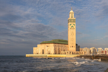Casablanca, Morocco: Sunset over the famous Hassan II mosque and minaret by the Atlantic ocean in...