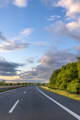 Sunset highway. Empty road. Communication tower