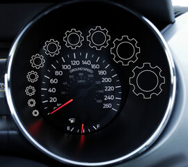 Curved line made with outlines of transparent gears of increasing size around the speedometer scale of the car
