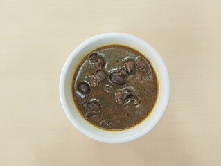 Sayur tutut pucung or snail soup with spices, Indonesian food, Flat lay 