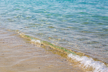Background with coast line of sea, pebbles and sand at the beach