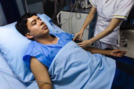 Nurse inserting intravenous line for patient care in hospital