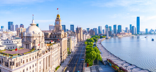 Aerial view of Shanghai skyline with winding river at sunrise.