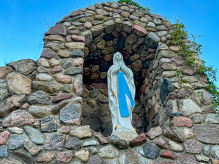 Figure of Mary in a grotto (similar to the one in Lourdes, France) in the garden of the Minor Basilica of Our Lady Listening Patiently in Rokitno