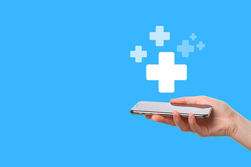 A hand holds a smartphone displaying health-related icons on a bright background