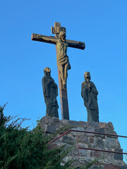 The Lord Jesus on the cross and two women under the cross in the garden at the Minor Basilica of Our Lady of Listening Patiently in Rokitno, Poland