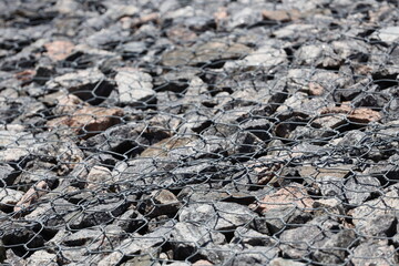 Deserted rocky terrain with a wire fence marking the boundary