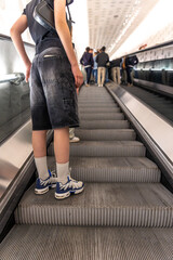 Passenger on escalator. Urban motion. Modern interior.