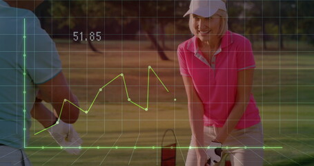 Standing golfers in pink polo and blue polo on fairway holding clubs, grid, graph showing 51