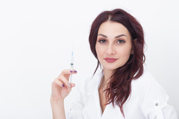 A syringe for injections in the hands of a cosmetologist.