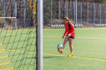 Girl on the soccer field. Soccer training. Active lifestyle. Football concept.