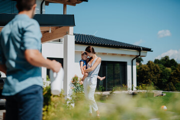 Joyful family moment in backyard with child