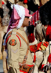A Camel Corps soldier carries a falcon during a national event west of the Jordanian capital, Amman.