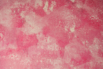 Soft pink textured plaster wall background