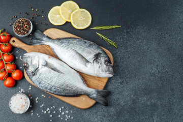 Dorado  fish with  tomatoes,  lemon and spices on cutting board