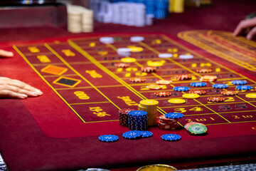 Close up of a Roulette Table. People play poker in the casino. Croupier behind gambling table in a...