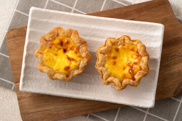 Delicious puff pastry Portuguese egg tart Pastel de nata in flower shape.