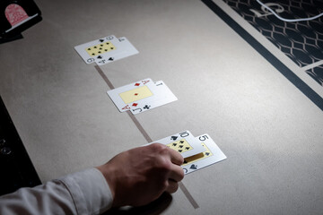 Croupier hands dealing cards on t blackjack poker table, gambling table with cards and chips....