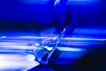 Security Breach Concept with Hacker in Blue Lighting Environment