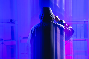 Mysterious Figure in Hoodie Engaged in Cyber Security and Coding