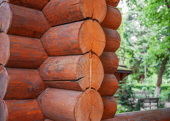 Rustic texture and rich brown color of a log cabin's corner, showcasing the natural rings and...