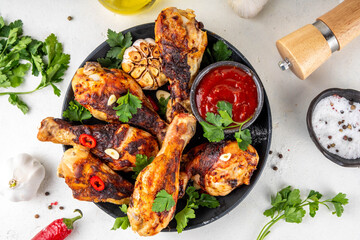 Grilled chicken legs with garlic, spices, parsley, bbq sauce and olive oil