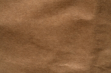 Close-up of old brown paper showing wrinkles, aging spots, and natural texture