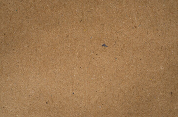 Close-up of old brown paper showing wrinkles, aging spots, and natural texture