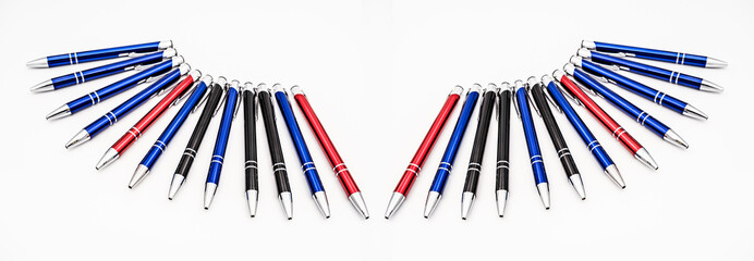 metal pens arranged on white background
