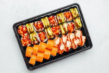 Delicious sushi platter featuring various rolls and salmon pieces
