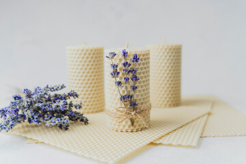 Handmade beeswax candles decorated with lavender close up