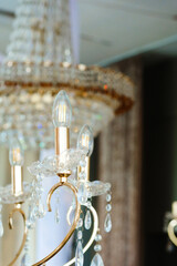 Elegant crystal chandelier illuminated with warm light in a grand venue