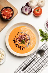 Top view of cold tomato soup, salmorejo, served with iberico jam.