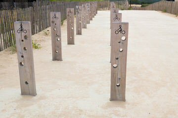 wooden bicycle rack stand line in wood drilled for the passage of bike padlock locks anti-theft