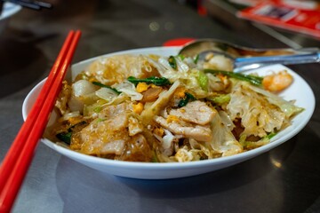 Delicious Asian Stir fried Noodles with Pork and Vegetables in a Bowl A Close Up Shot of Savory Food