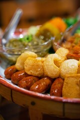 Delicious Thai Food Platter Savory Sausages Crispy Pork Cracklings and Dipping Sauces
